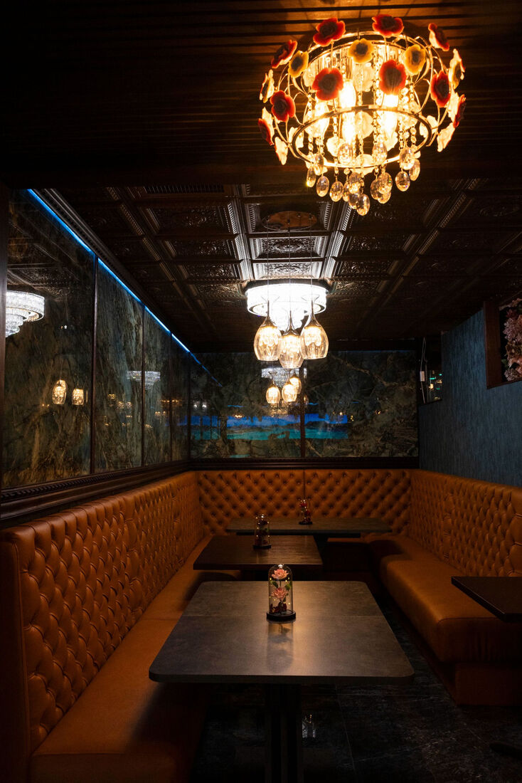 Intimate den with chandelier and leather booths